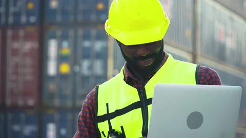 African american container worker using computer laptop checking list inven.. Stock Footage 248348396