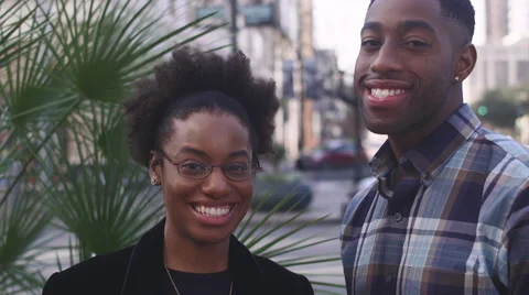 African American couple in the city smiling at the camera Stock Footage