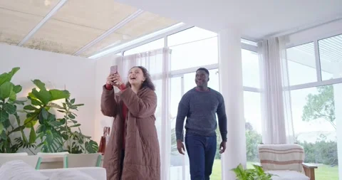 African American couple entering home, woman scanning phone, couple posing for Stock Footage 339231853