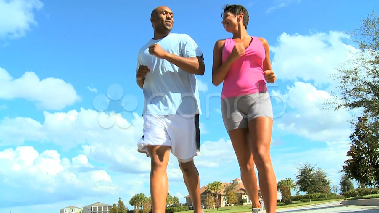Jogging couple. African american persons man and woman running