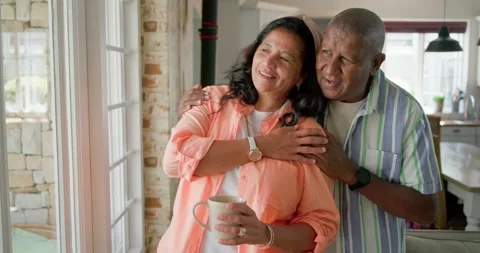 African American couple by kitchen window, man placing hands on her, woman Stock Footage 342113432