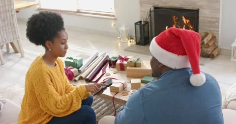 African American couple opening gift list on tablet and scrolling to pick gifts Stock Footage 336242524