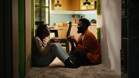 African American couple, solving problems, discussing in dark hallway Stock Footage 333554437