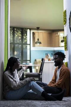 African American couple, solving problems, discussing in dark hallway 写真素材