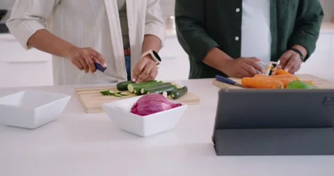 African American couple using tablet to cook dinner in kitchen, prepping Stock Footage 342843710