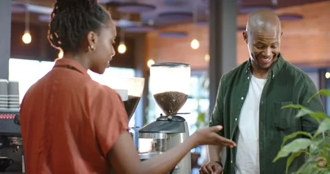 African American customer speaking pointing barista tapping register taking Stock Footage 344333685