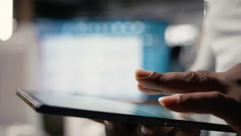 African american developer evaluating 3D models blueprints and digital software Stock Footage 316793956