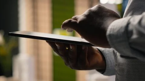 African american developer evaluating 3D models blueprints and digital software Foto stock