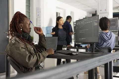 African american developer pondering on solutions to improve web project 写真素材