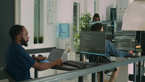 African american developer using laptop to write code and display system Stock Footage 220895626