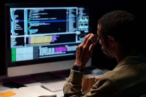 African American Developer Working Late at Night Foto stock