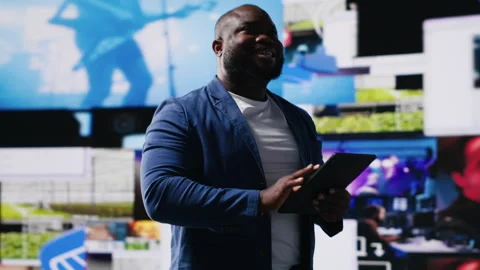 African american digital creator interacting with high tech visuals and screens Stock Footage 312305159