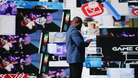 African american digital creator interacting with high tech visuals and screens Stock Footage 312414325
