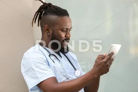 African American Doctor Checking His Tablet Computer