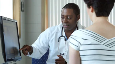 African american doctor consulting with a female patient Stock Footage