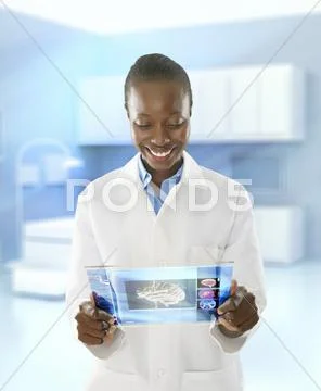 African American Doctor Using Digital Tablet In Doctor's Office