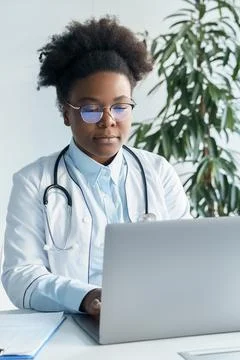 African American doctor using laptop computer in medical work or education Stock Photos