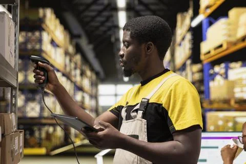 African american e-commerce worker scanning shipping labels numbers Stock Photos
