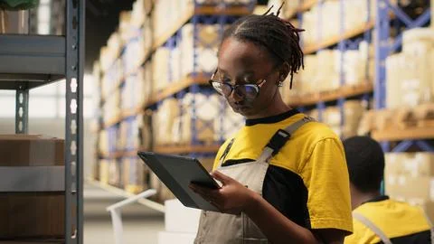 African american e-commerce worker scanning shipping labels numbers Stock Photos