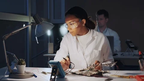 African american electronics engineers checking motherboard with multimeter Video stock 112866302