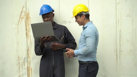 African american engineer sitting and holding laptop computer talking with bu Stock Footage 154689435