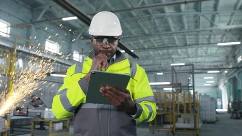 African american engineer works with tablet in production. Employee develops new 스톡 동영상 240087336