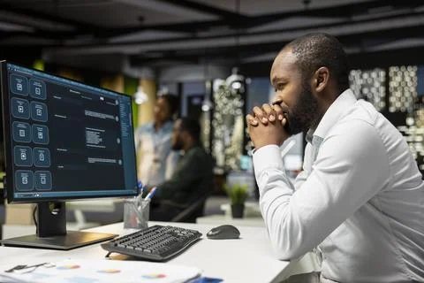 African american expert programming software code on desktop pc 写真素材