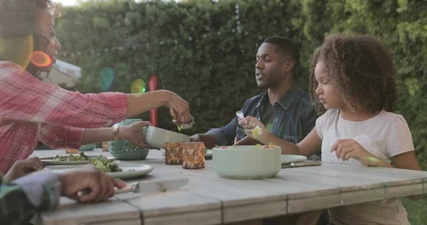African American family having a family meal outdoors Stock Footage
