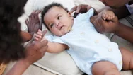 African American Family Parents Take Care Of Cute Baby In Garden Of House. Stock Footage
