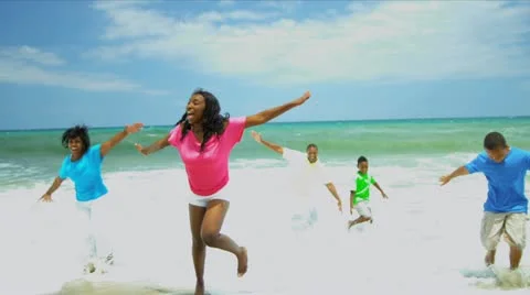African American family spending summer holiday together on beach   Stock Footage