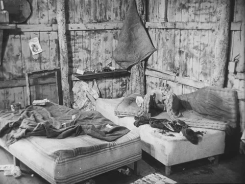 African-American family unhappily surveys unmade beds in an unkempt cabin. Stock Footage