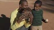 African American Father Playing Baseball With Son Stock Footage