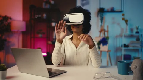 African American female developer in a VR headset creates a new video game 스톡 동영상 303697488