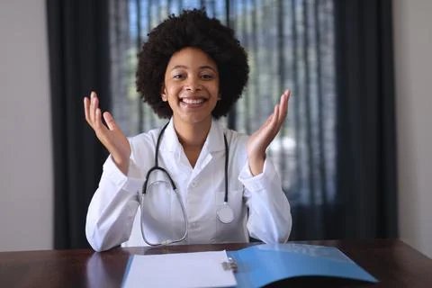 African american female doctor sitting making video call consultation Stock Photos