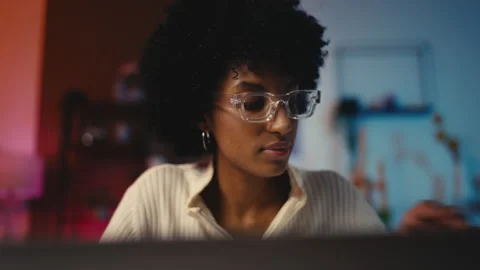 African American female programmer codes on her laptop, developer occupation Stock Footage 303697356