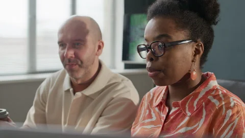 African American Female Programmer Working with Colleague in Office Stock Footage 306844924