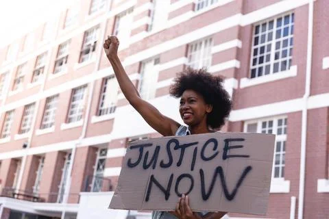 African american female protester on march holding a homemade protest sign Stock Photos