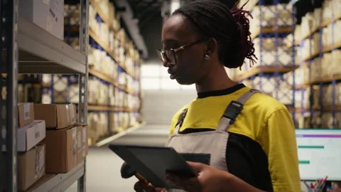 African american female worker using barcode scanner on shipping labels Stock Footage 315704562