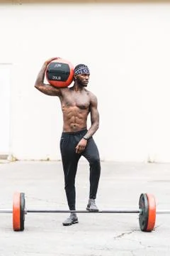 African American Fitness Model holding a medicine ball Stock Photos