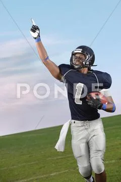African American football player cheering in game Stock Photos