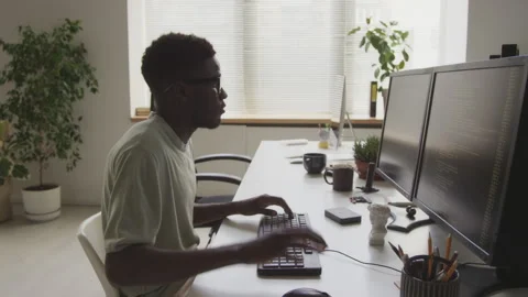 African American Geek Writing Program Code on Computer in Office Stock Footage 255780610