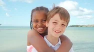 African American Girl And Caucasian Boy Smiling Together In Close Up Stock Footage