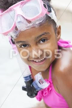 African american girl child in swimming pool with goggles Stock Photos
