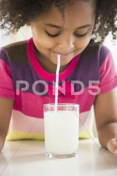 African American Girl Drinking Glass Of Milk