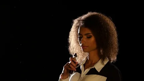 African american girl smokes an electronic cigarette in an empty room. Black Stock Footage