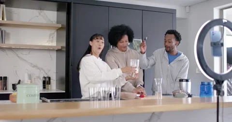 African American group starting camera filming passing blender jar and slicing Stock Footage 345607652