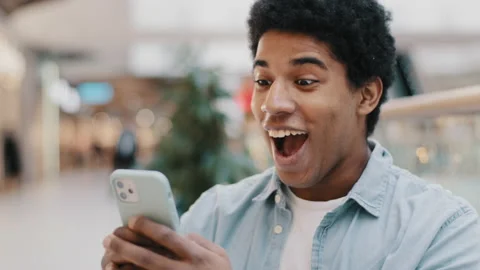 African american guy surprised by message received wins online bets looking at Video stock 169929806