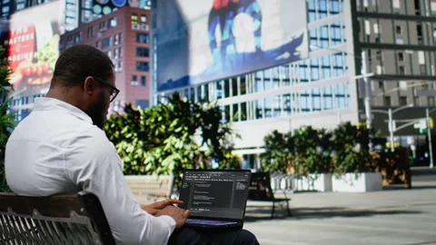 African american guy works on programming code on terminal window Stock Footage 324307746