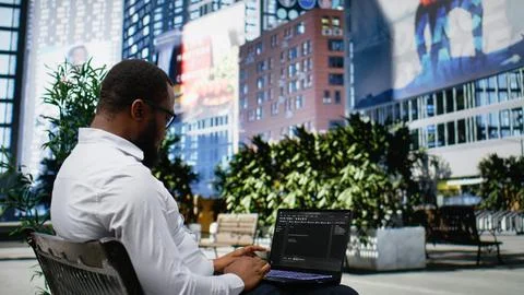 African american guy works on programming code on terminal window 스톡 사진