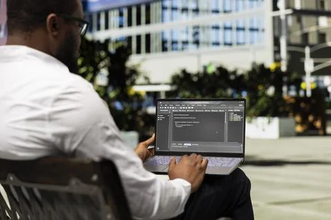 African american guy works on programming code on terminal window Stockfoto's